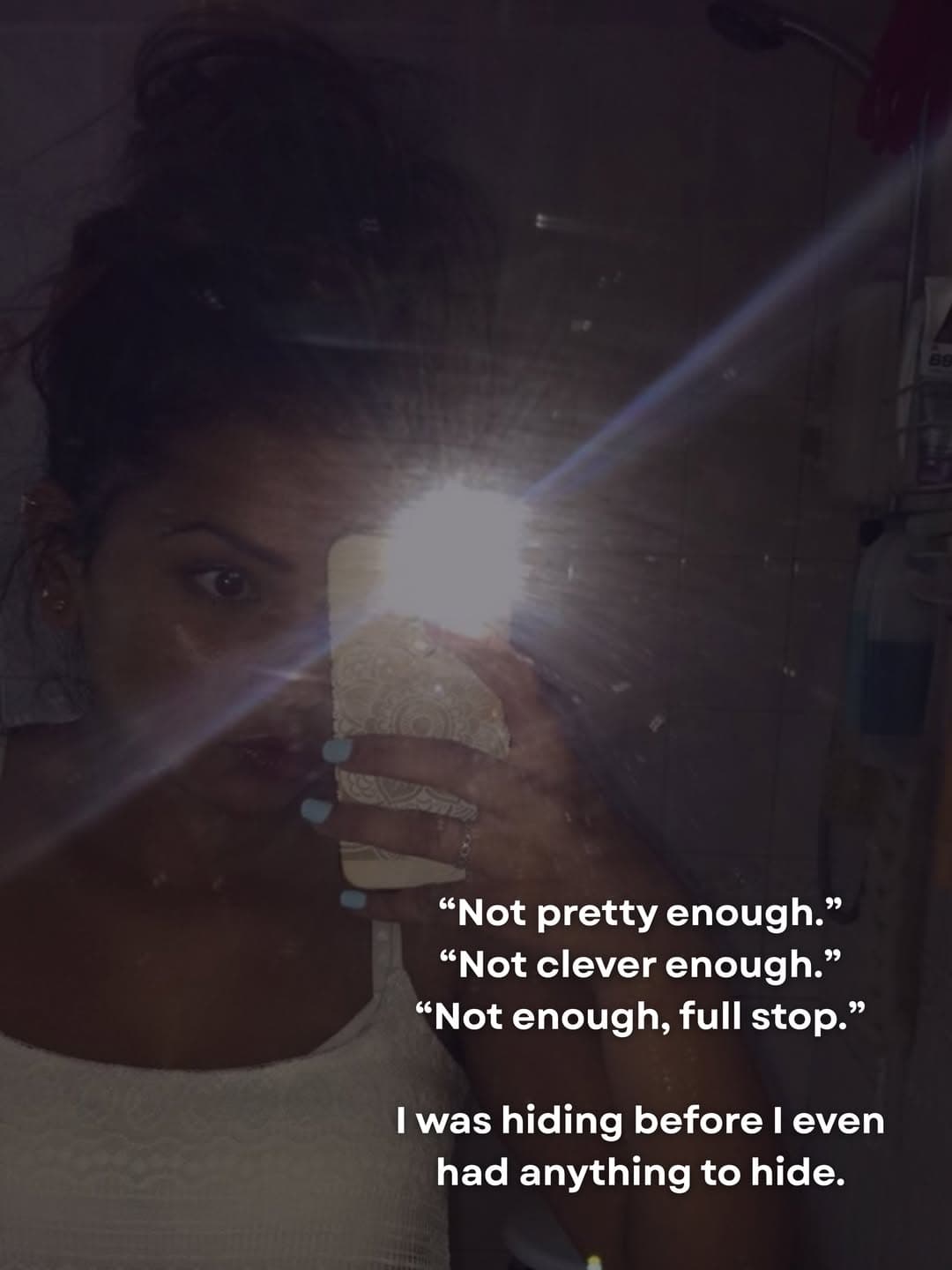A low-light bathroom mirror selfie, the camera flash hiding most of Kiara's face.